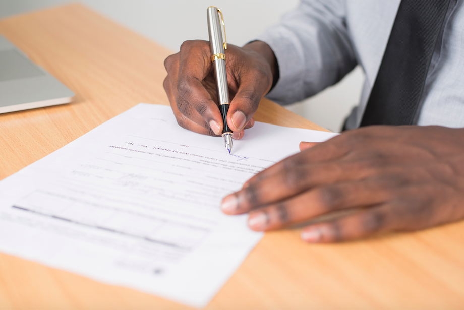 man-signing-mortgage-application